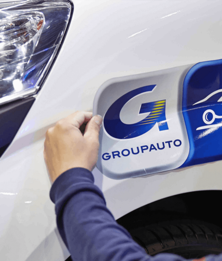 Groupauto sticker being place on a car